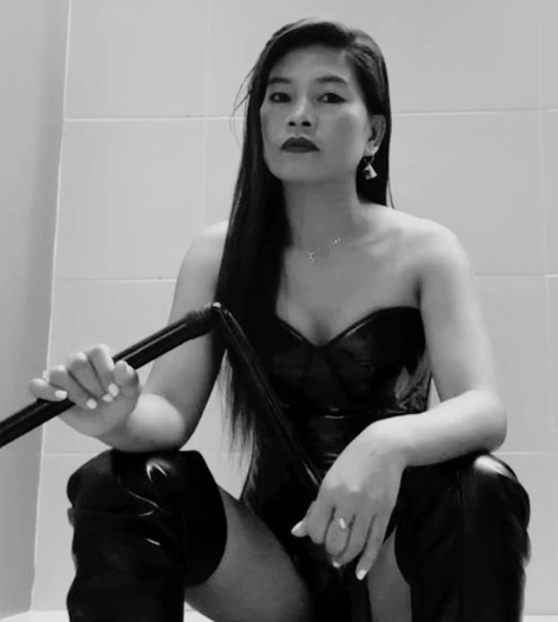 Queen Sierra seated with a riding crop, professional dominatrix in Manila