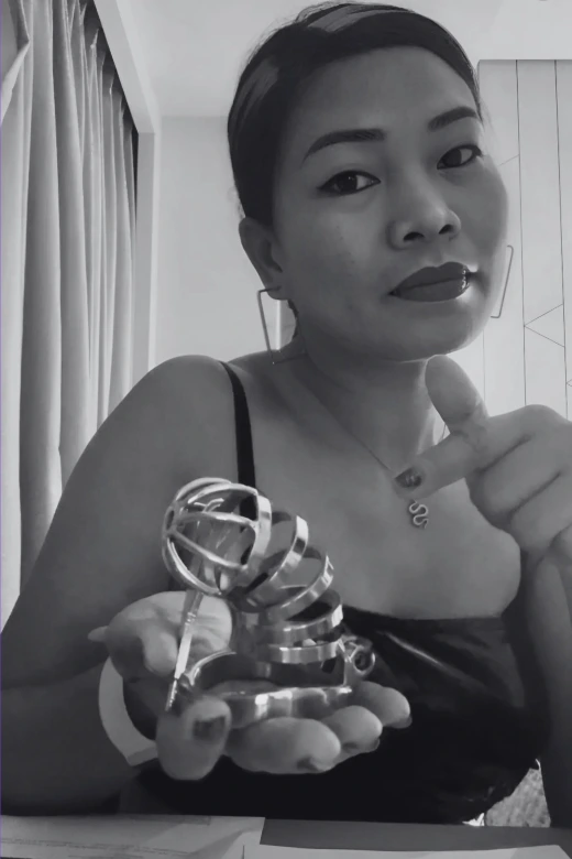 Queen Sierra holding a chastity cage, professional dominatrix in Manila
